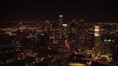 Night drone view above Los Angeles featuring glowing high rise towers Stock Footage 344389941