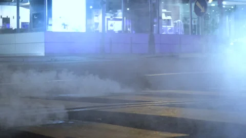 Night empty street with dense smoke, hot steam air comes out of sewer manholes Stock Footage 293715649