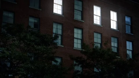 Night Establishing Shot of Apartment Building Lights Turning On Stock Footage