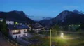 Night falling on beautiful comfy cottages in mountain area, European village 4k or 4k+ Resolution