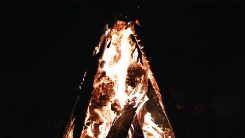 At night, the fire burns brightly, and the camera captures it in slow motion. Stock Footage 343796818