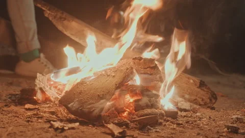 Night fire glow. Illuminated logs flicker emitting crackling sounds and smoke Stock Footage 338010467
