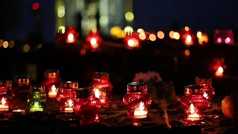 Night fires burn in small red lamps during the Holodomor memorial ceremony. Stock Footage 144113782