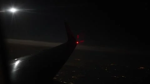Night flight airplane wing full moon city lights sky view dark horizon peaceful  Stock Footage 310052407