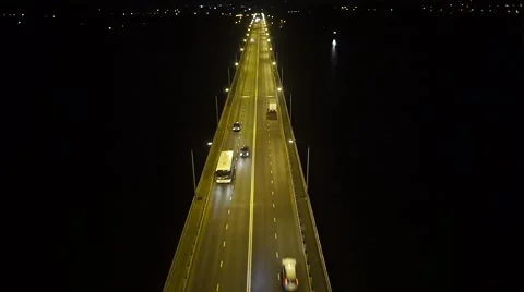 Night flight over the road bridge with heavy traffic Stock Footage 68880458