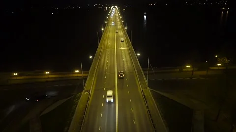 Night flight over the road bridge with heavy traffic Stock Footage 68880593
