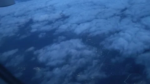 Night flight. Plane window view to the clouds. Cloudy sky above the city. Vidéo 331315084
