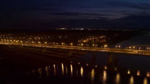 Night flight shot through a river with view to Main Ufa city bridge Stock Footage 128145271
