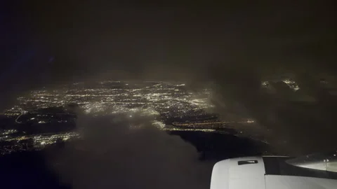 Night flight through clouds with a cityscape of lights below Stock Footage 264073632