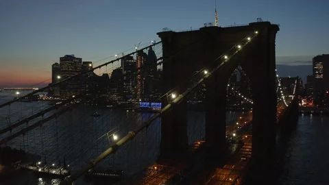 Night flying along Brooklyn Bridge towards downtown Manhattan view Stock Footage