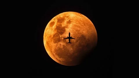 Night flying in the sky in front of the full moon light. Stock Footage 172127283