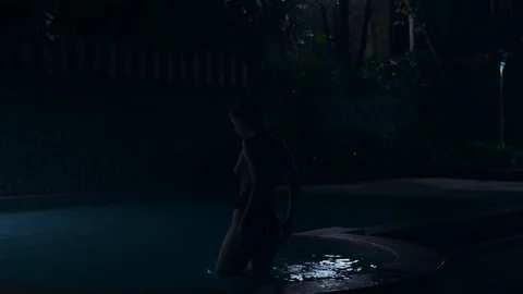 Night footage of beautiful girl with sexy body in bikini in swimming pool Stock Footage