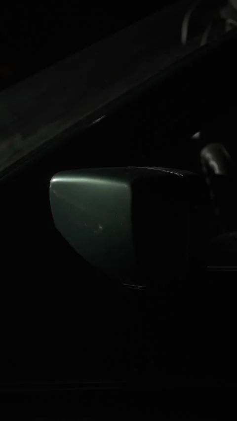 Night frame from the side of the green car that includes the rear view mirror. Video stock 257017494