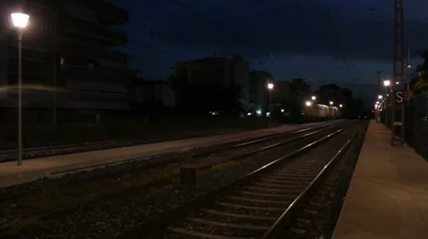 Night freight train aproaches and passes by. Stock Footage 8646903