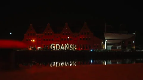 Night "GDANSK" sign with reflection and foreground Stock Footage 338324768