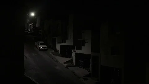 Night gloomy shot of a suburban street with dimmed light Stock Footage