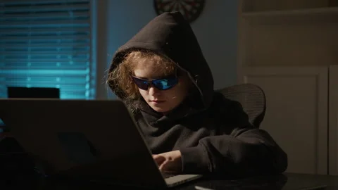 Night hacker child working on computer. Hooded hacker kid in cyber crime Stock Footage 342790707