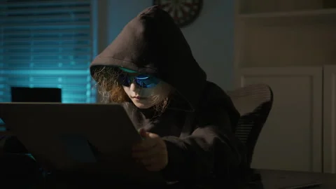 Night hacker child working on computer. Hooded hacker kid in cyber crime Stock Footage 346829127