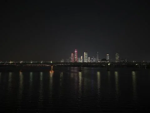 The night Han River skyline with lit towers reflected in the water, South Korea Stock Photos