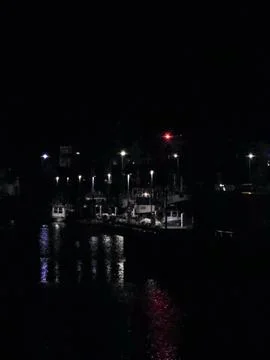 Night harbor with lamppost reflections Stock Photos