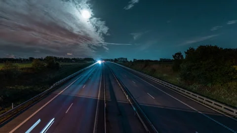 Night Highway Timelapse with Light Trails Under Moonlit Sky Stock Footage 342470408