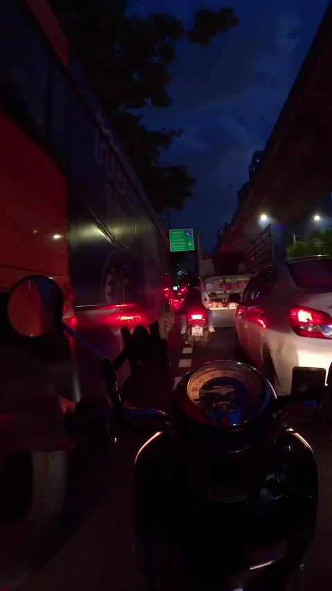 Night hyperlapse of motorcycle riding on road next to BTS Skytrain in Bangkok Stock Footage 263886005