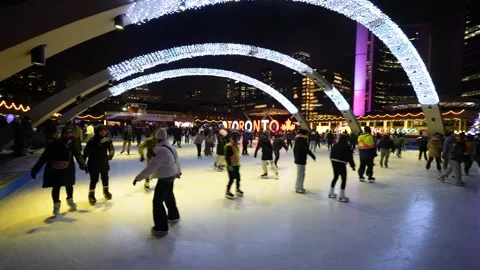 Night ice skating under festive arches at Nathan Phillips Square Stock Footage 330859533