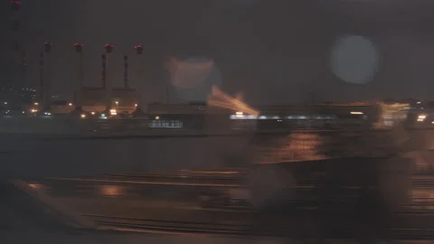 Night Industrial view from train window. Pipes of the thermal power plant Stock Footage 134020016