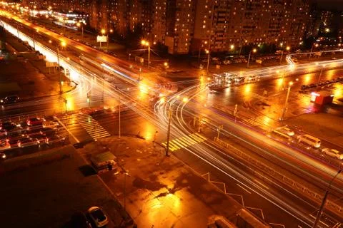 Night intersection road lights exposure landscape. Living buildings on backgr Stock Photos