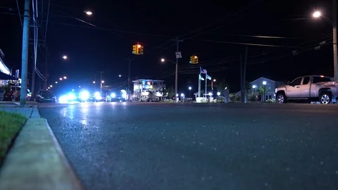 Night intersection with traffic light and cars passing Stock Footage 95687821