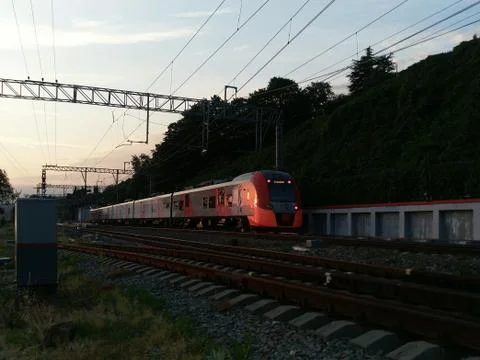 Night landscape with a train and the sunlight of the sunset Stock Photos