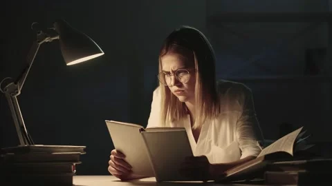 Night learning hard task troubled student textbook Stock Footage 149339440