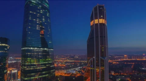 Night Light timelapse video with modern glass buildings on at dawn in Moscow. Stock Footage 66539569