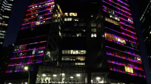 Night lighting of skyscraper office. Below is fitness room. Contains people. Video stock 53983770