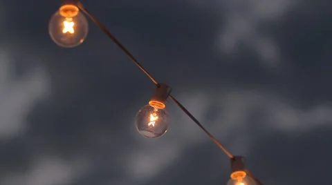 Night Lights | Ambient Mood | String of outdoor Edison bulbs close up Stock Footage