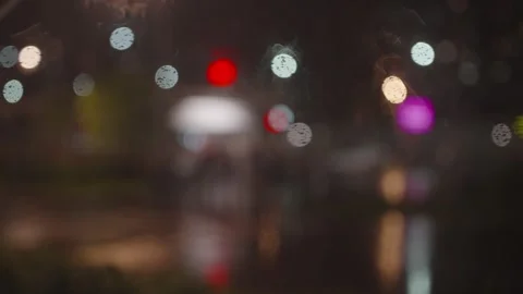 Night Lights Bokeh and Wet Street Reflections With Blurred City Figures Creating Stock Footage 340899489