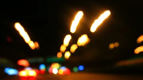 Night lights streak as we travel down a city street Stock Footage