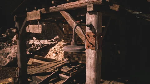 Night lit rustic mining structure with tools in the background Stock Footage 331399567