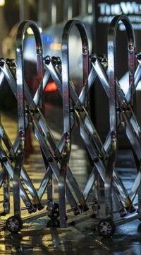 Night lite soft focus back grounds over metal railing and rain drops Stock Photos