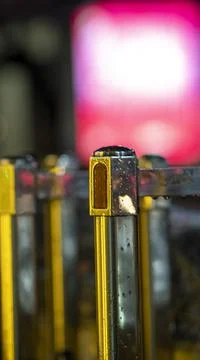Night lite soft focus back grounds over metal railing and rain drops Stock Photos