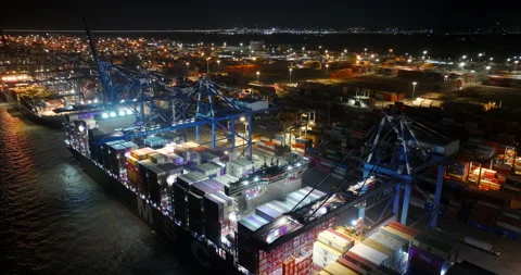 Night loading of cargo containers onto ship for international freight delivery. Stock Footage 319386285