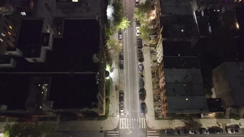 Night looking straight down a lamplit residential street Stock Footage 274364925