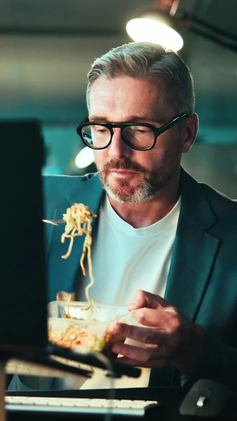 Night, man and eating in workplace with computer, internet and SEO trend Stock Footage 343549497