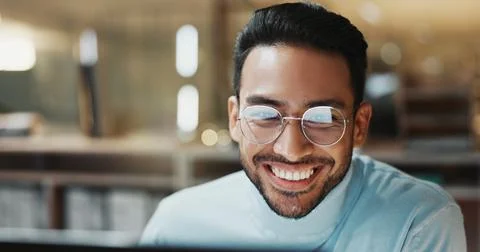 Night, man or happy with computer at agency for breaking news, draft editing or Stock Photos