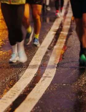 Night marathon runners crowd in the rain, sportsmen participants start runn.. Stock Photos