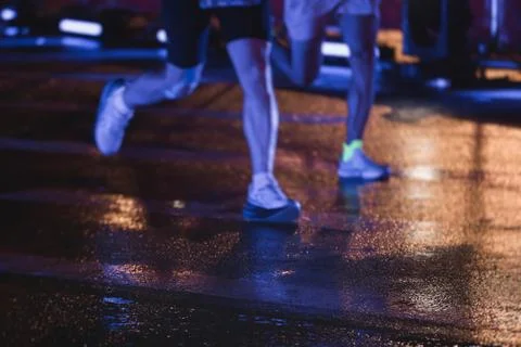 Night marathon runners crowd in the rain, sportsmen participants start runn.. Stock Photos
