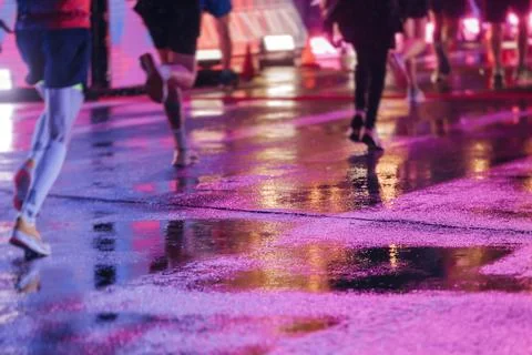 Night marathon runners crowd in the rain, sportsmen participants start runn.. Stock Photos
