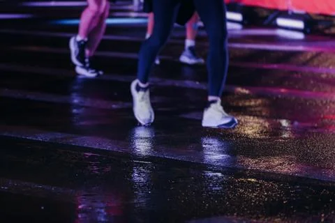 Night marathon runners crowd in the rain, sportsmen participants start runn.. Stock Photos