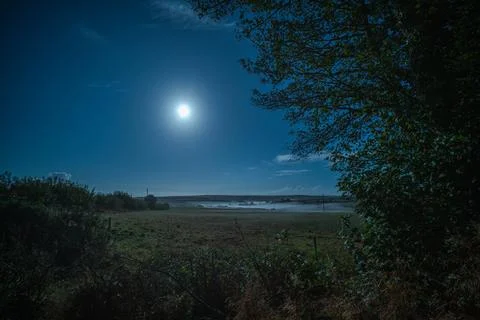 Night mist forms over a moonlit Cornish valley near Looe Фото
