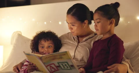 Night, mom and reading book with kids in bedroom for story time, fantasy or Stock Footage 335319979
